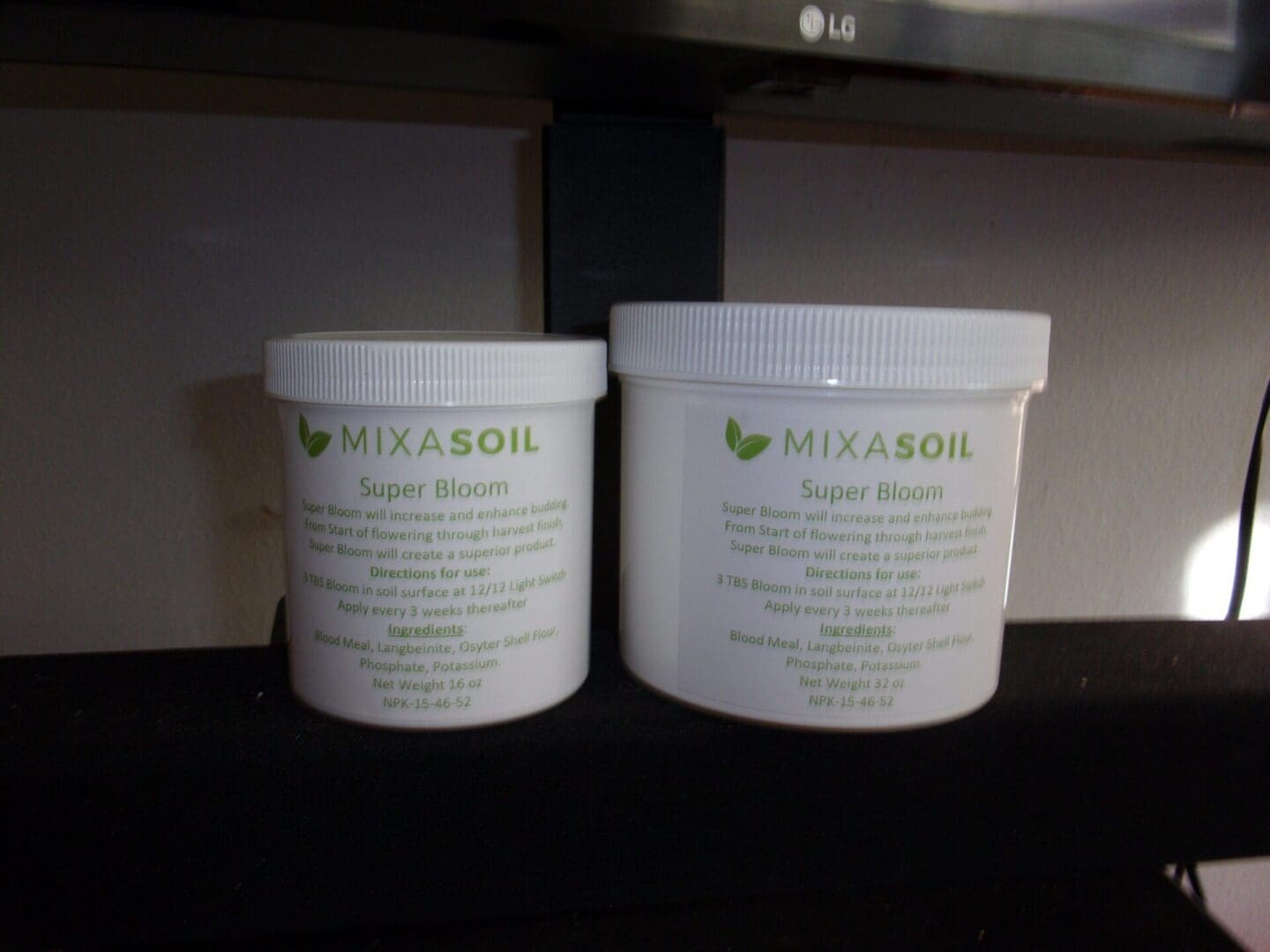 Two containers of body butter sitting on a shelf.