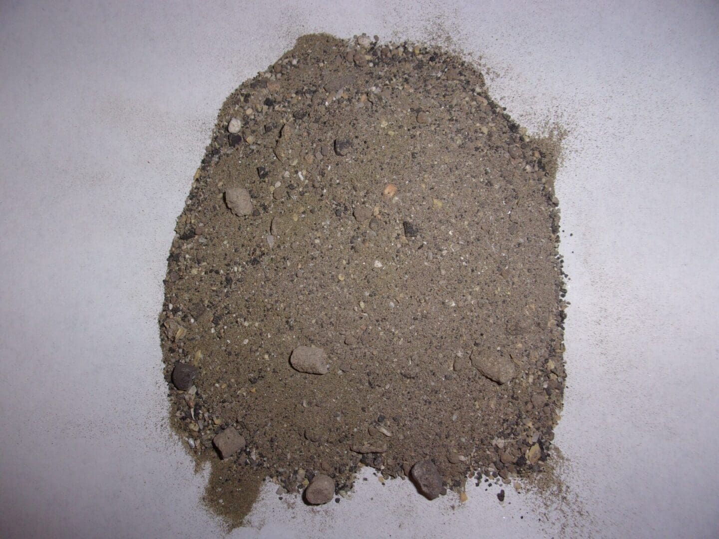 A pile of dirt on top of the floor.